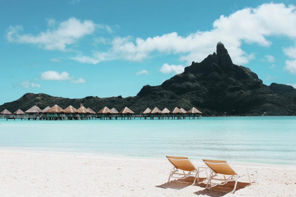 Beach chairs overlooking clear Caribbean waters 